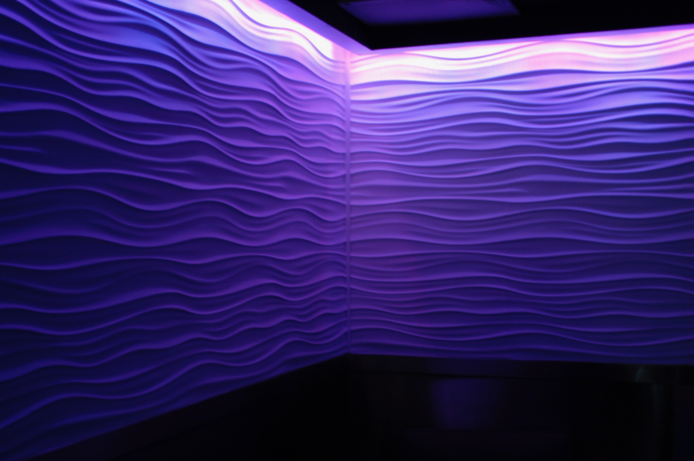 Illuminated wave wall detail at Blue Bar
