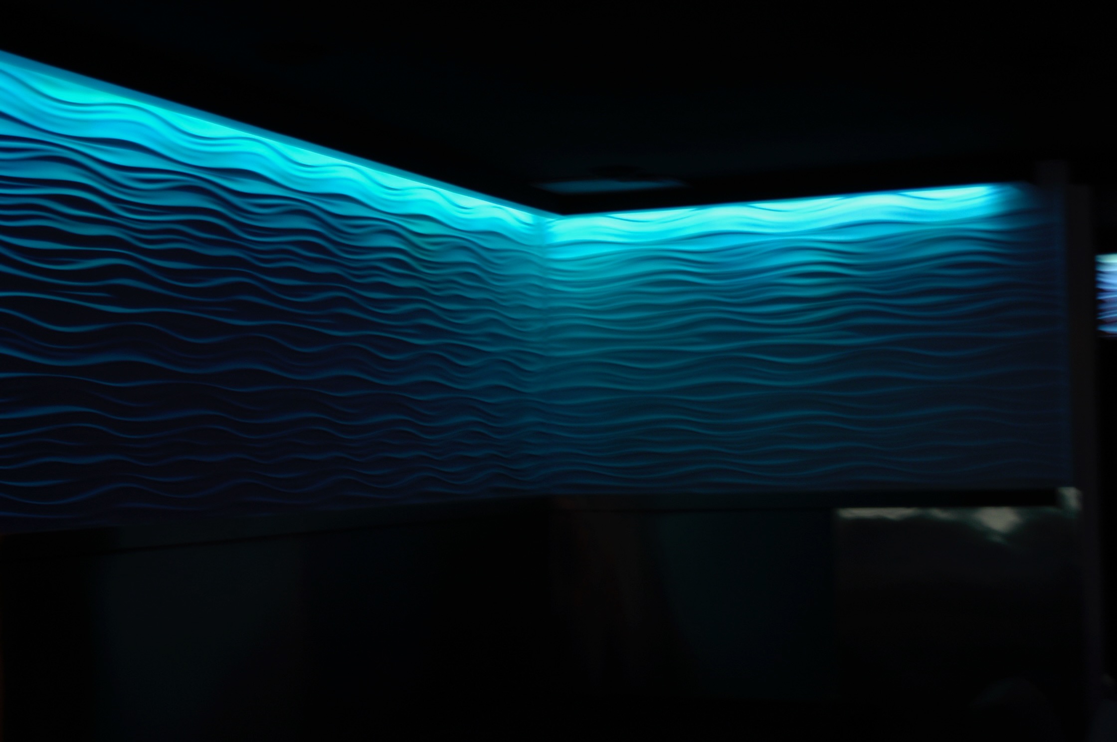 Blue Bar interior with a glowing blue wave wall and layered lighting
