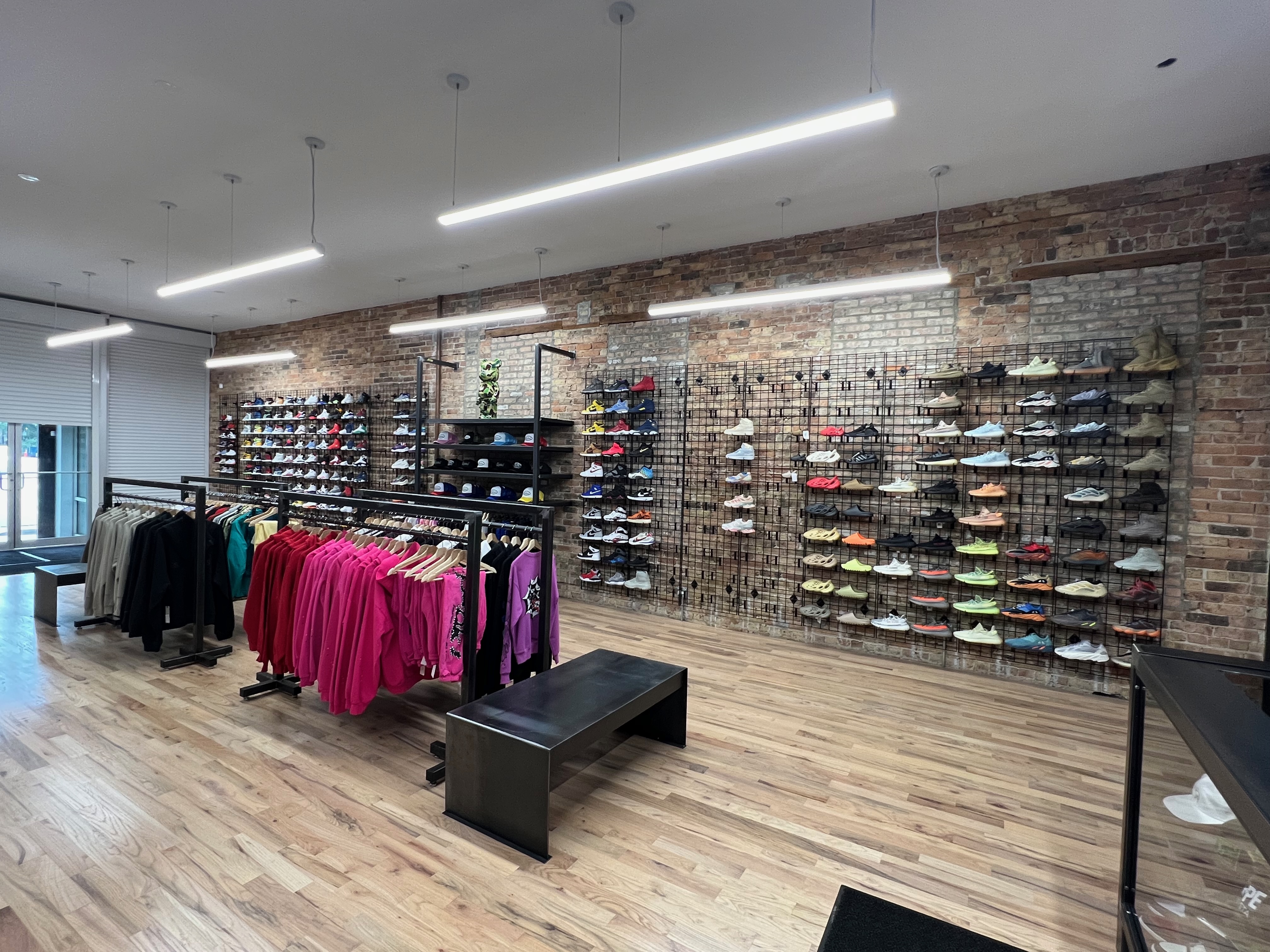 Wide view of the finished Boneyard retail interior with custom metal display fixtures and exposed brick