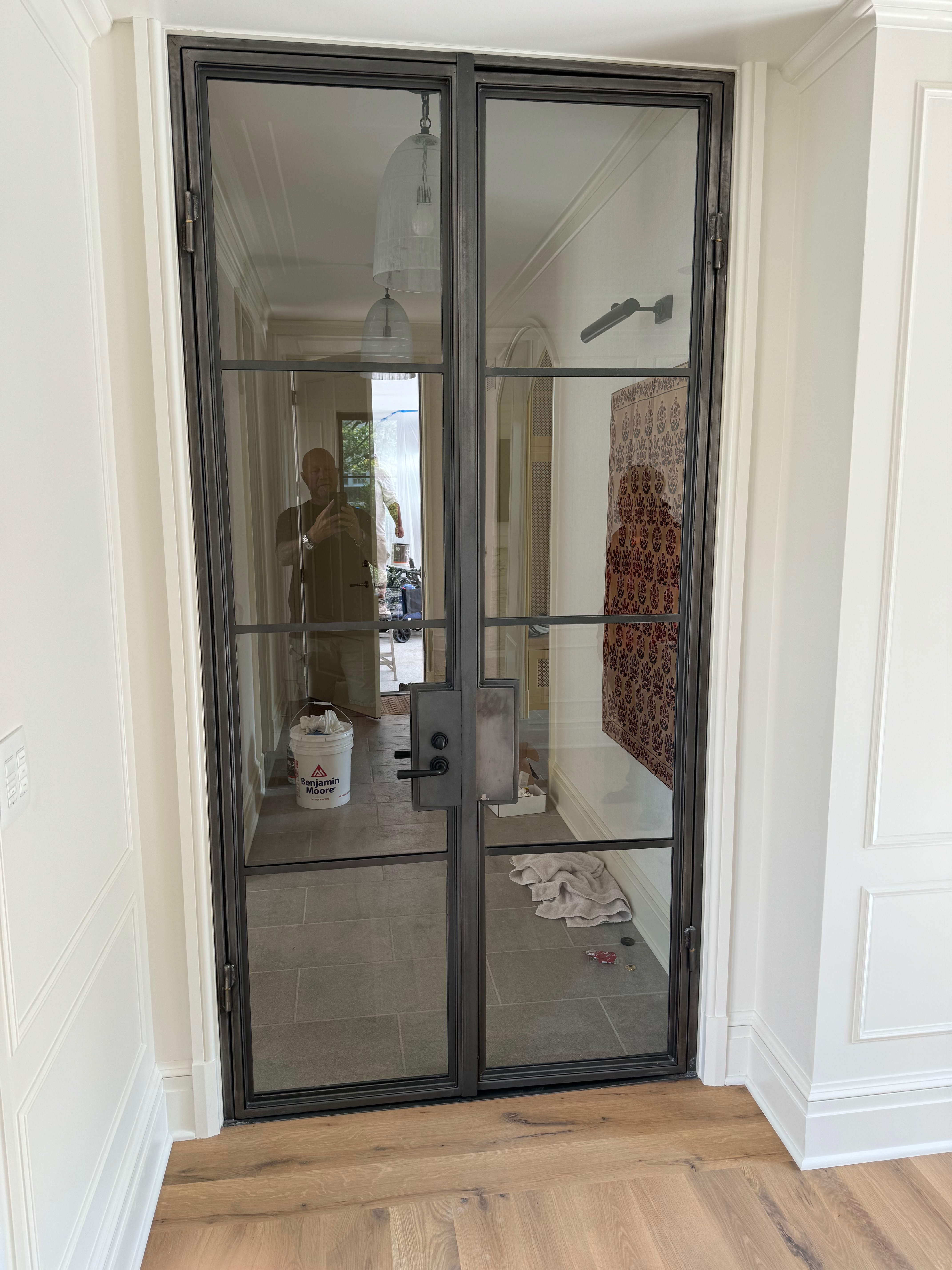 Finished steel-and-glass interior partition with strong grid proportions