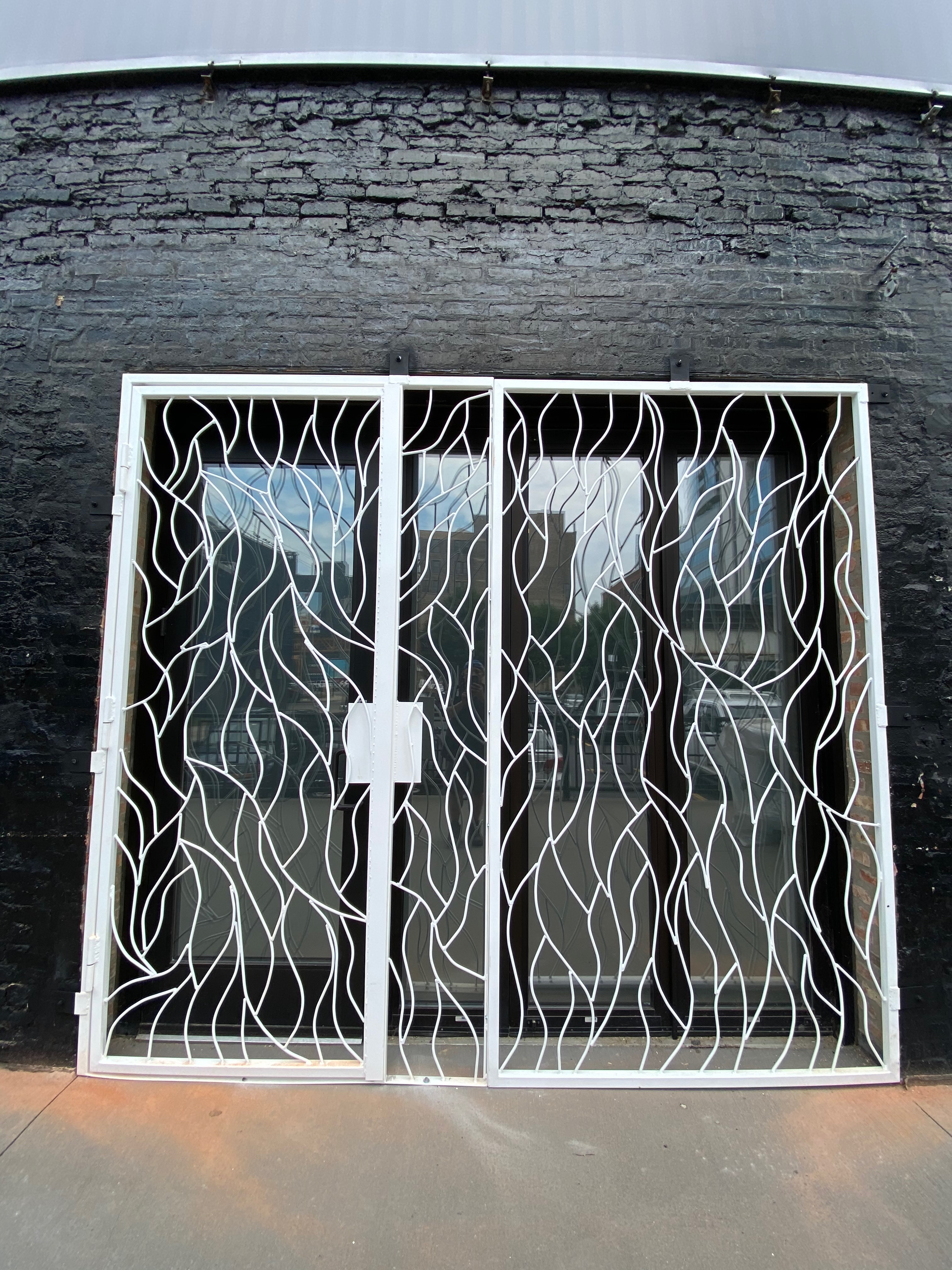 Angled exterior view of the Moca storefront and vine-pattern ironwork