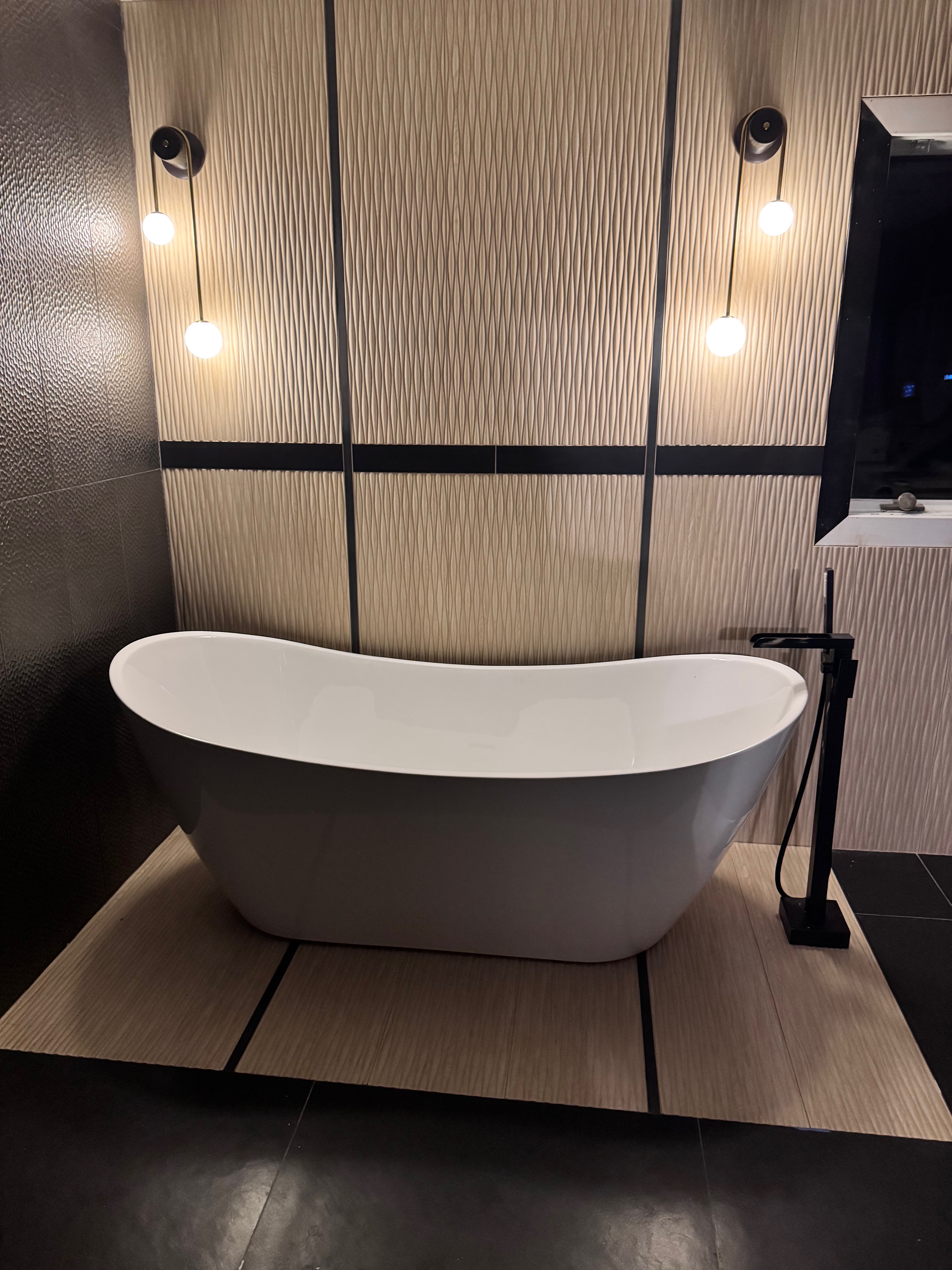 Spa bath with freestanding tub and quiet stone finishes at Robinwood
