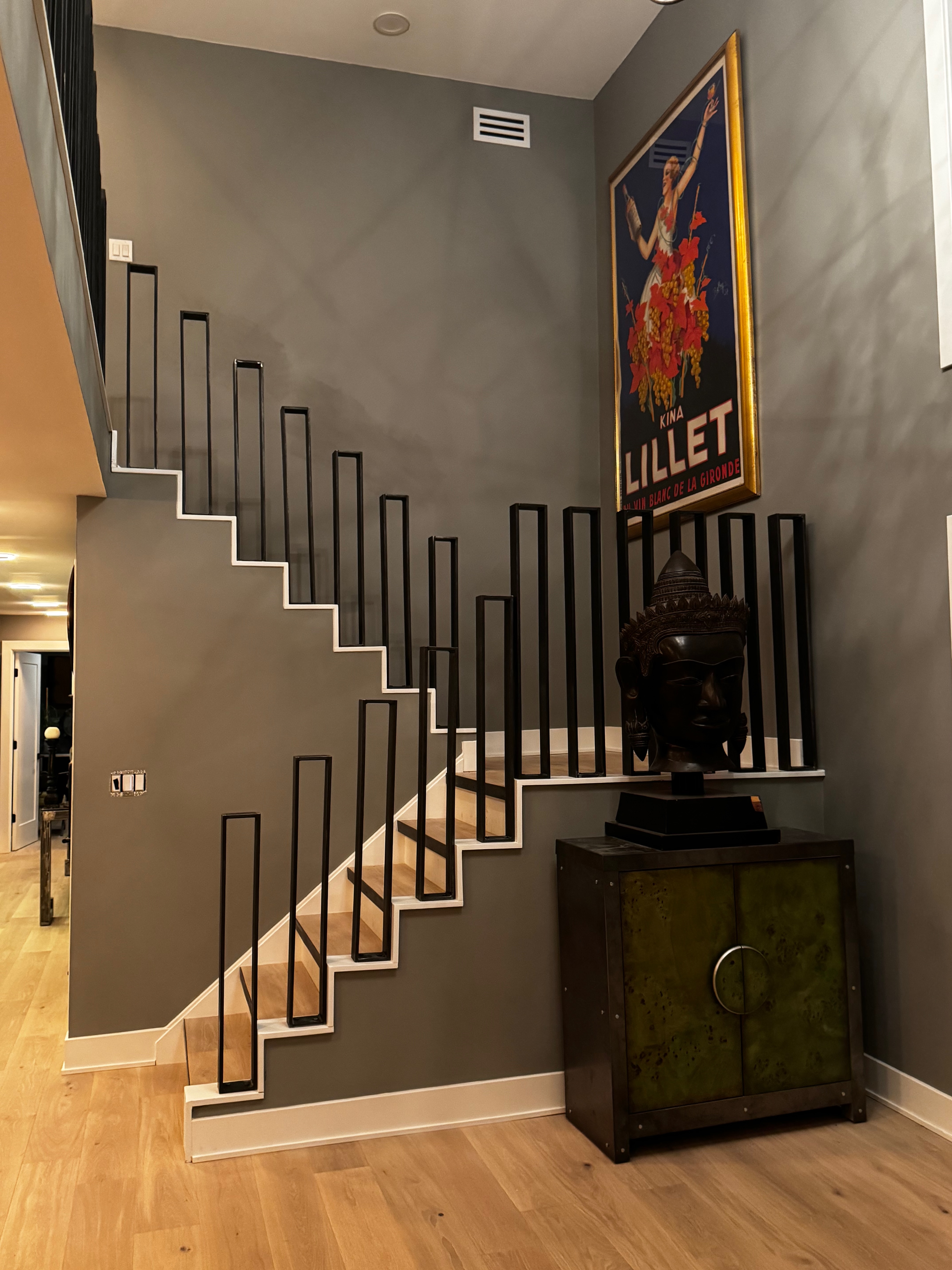 Finished view of the sculptural black steel staircase in the Robinwood home